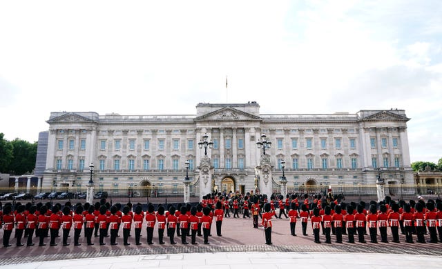 The coffin of the Queen, draped in the Royal Standard with the Imperial State Crown placed on top, is carried on a horse-drawn gun carriage