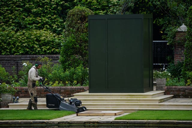 A gardener works in the Sunken Garden at Kensington Palace, London, the former home of Diana, Princess of Wales