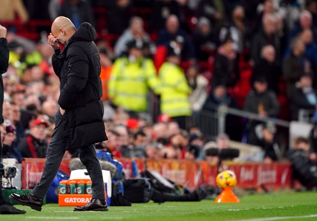 Pep Guardiola puts his hand to his head in frustration as he walks back to his dugout