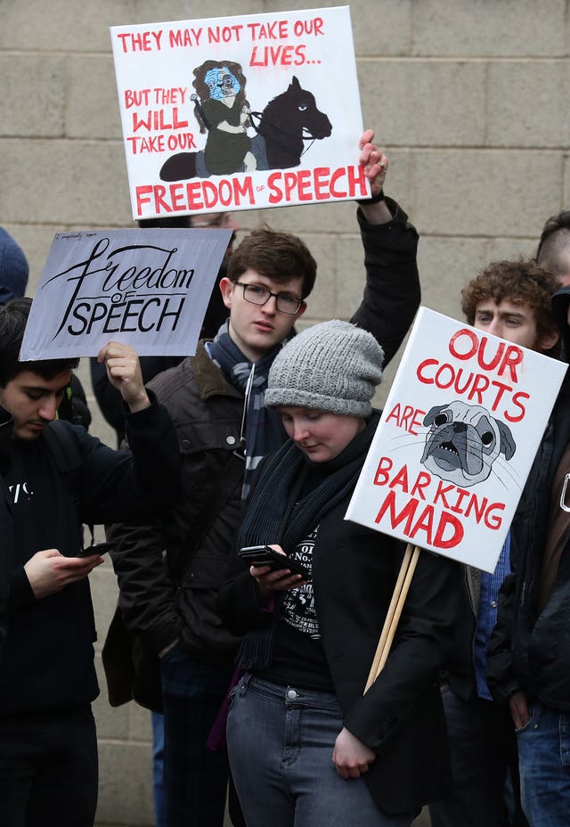 Supporters of Mark Meechan hold posters defending freedom of speech (Andrew Milligan/PA)