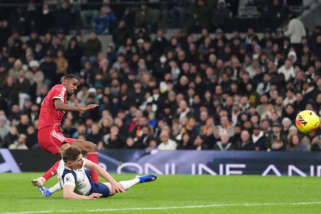 Alexander Isak, left, is caught by Micky van de Ven as he scores Liverpool’s first goal against Tottenham