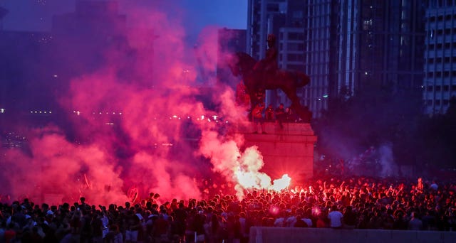 Liverpool fans let off flares outside the Liver Building 