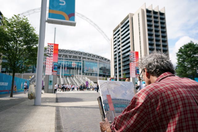 An artist paints a picture of the ground ahead of the Euro 2020 final at Wembley Stadium