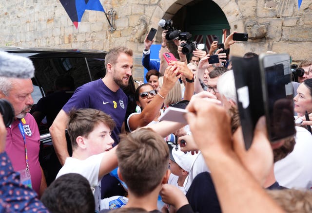 England’s Harry Kane poses for photos with fans