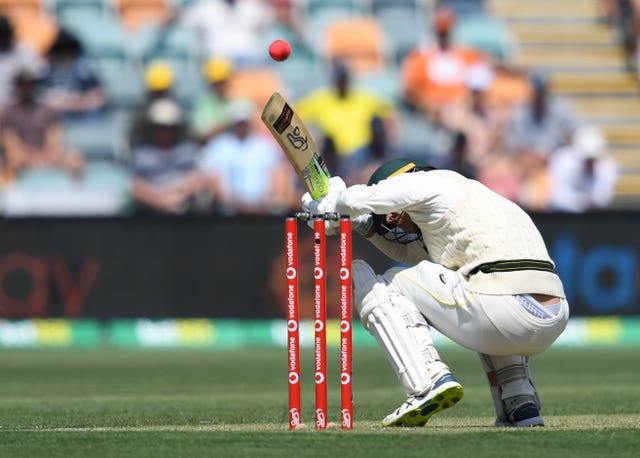 Australia’s Alex Carey ducks under a bouncer bowled by England’s Mark Wood