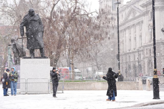 People in snowy conditions in Westminster, central London