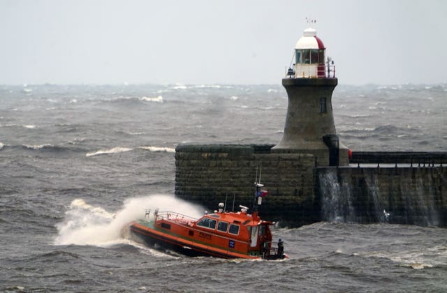 A pilot boat heads out of the Tyne, past South Shields lighthouse, in choppy conditions