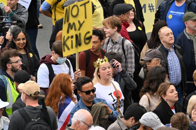 A protestor holds up a placard reading ‘Not My King in Trafalgar Square 