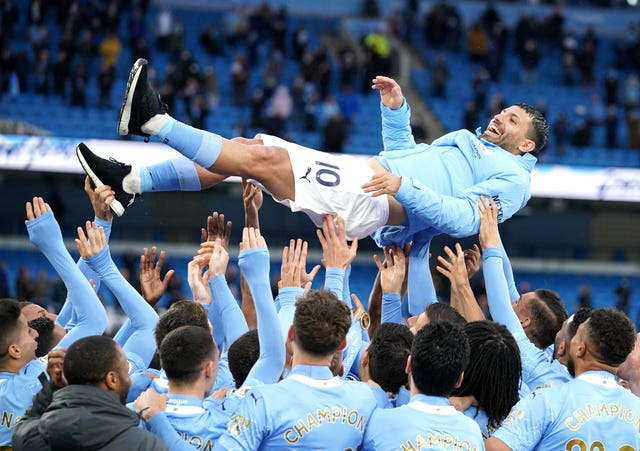 Manchester City’s Sergio Aguero is thrown into the air by his team-mates