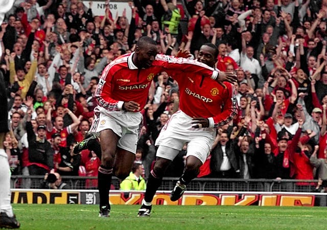 Andy Cole, left, celebrates with Dwight Yorke after scoring against Tottenham to clinch Manchester United's 1998-99 Premier League title