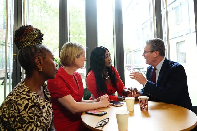 Sir Keir Starmer sitting at a table with three women