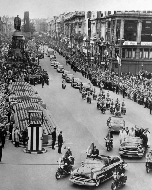 Crowds line O’Connell Street as far as the eye can see as President Kennedy stands in an open car (PA)