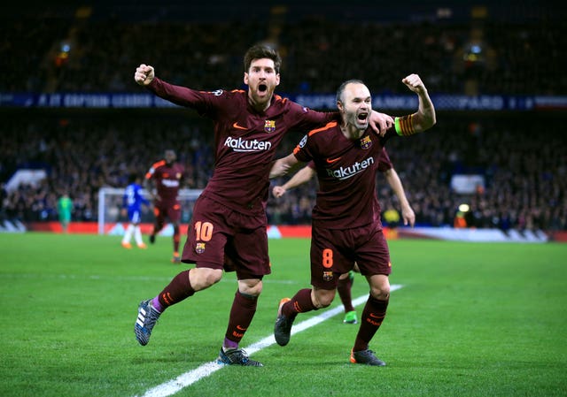 Messi celebrates with Andres Iniesta after putting his side in front at Stamford Bridge (Nick Potts/PA).