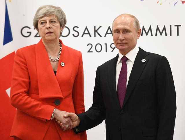 Theresa May shakes hands with Russian president Vladimir Putin