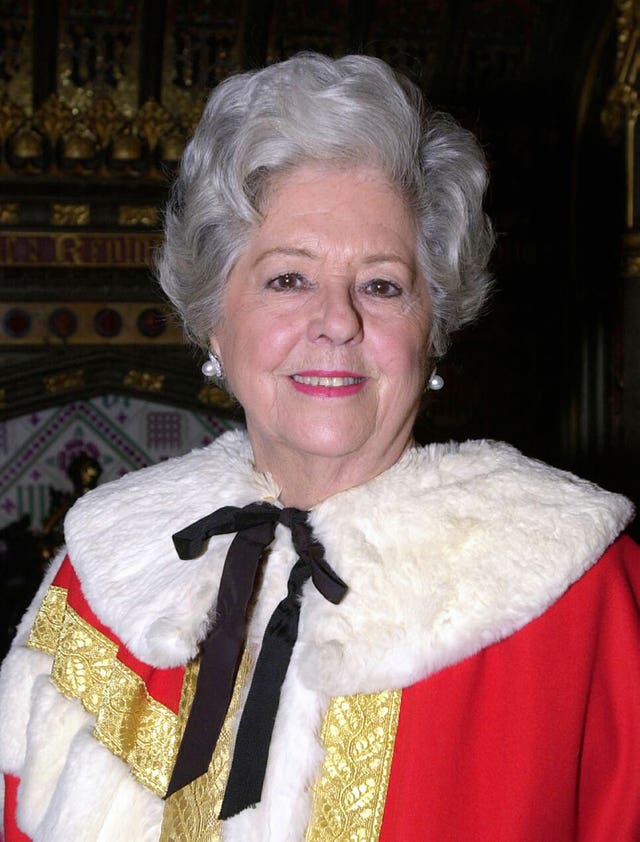 Baroness Betty Boothroyd donning her robes ahead of her introduction into the House of Lords