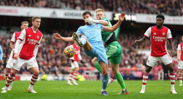 Manchester City's Ruben Dias challenges for the ball against Arsenal