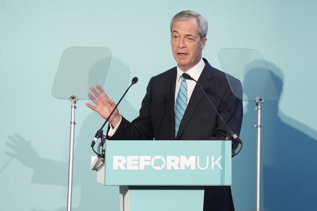 Nigel Farage speaking from behind a lectern in front of a turquoise backdrop