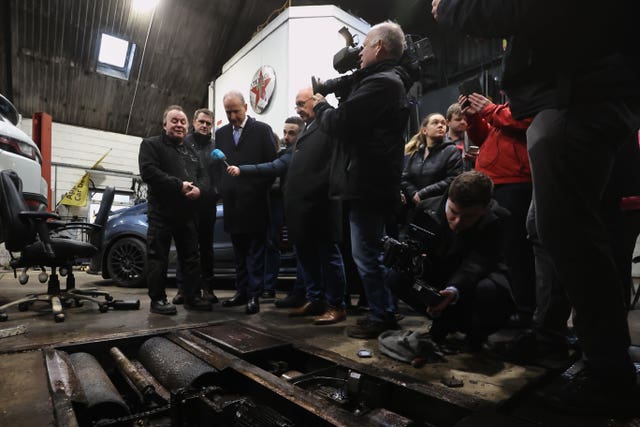 Taoiseach Micheal Martin talking to Brian Leacy (left), co owner of L&M Motors, whose premises were damaged in the recent flooding