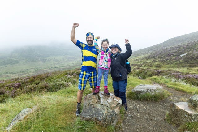 Paul Choat with his daughter Skye and Nicola Roseman chief executive of My Name5 Doddie Foundation on Schiehallion
