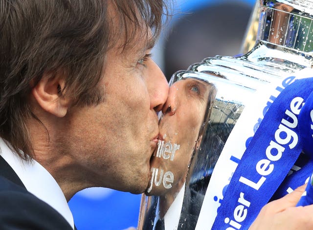 Chelsea head coach Antonio Conte kisses the Premier League trophy after it was presented to the Blues