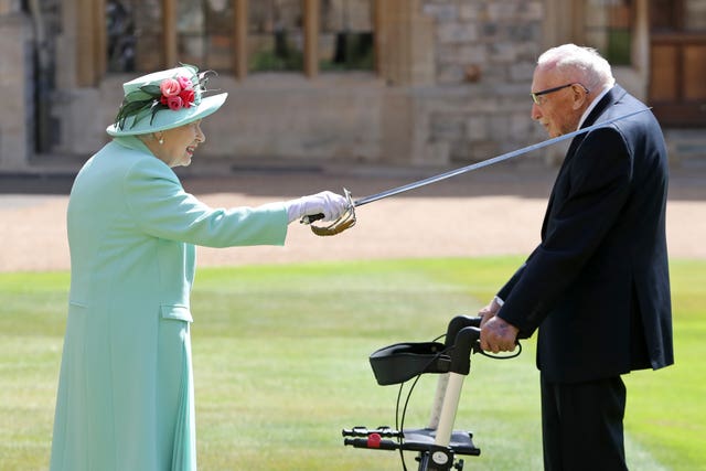 Captain Sir Tom Moore receives his knighthood from the Queen