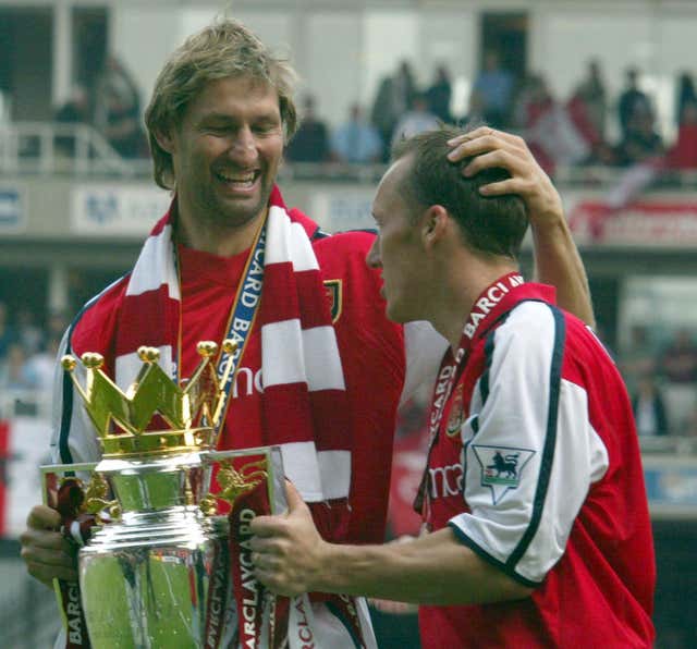Tony Adams and Lee Dixon celebrate with the Premier League trophy in 2002