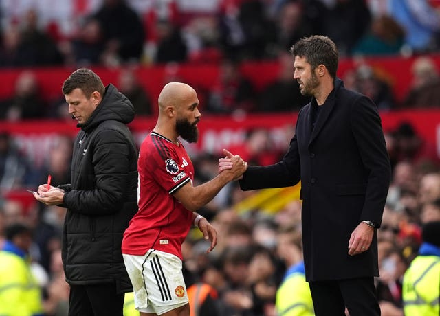 Manchester United’s Bryan Mbeumo greets interim head coach Michael Carrick as he is substituted 