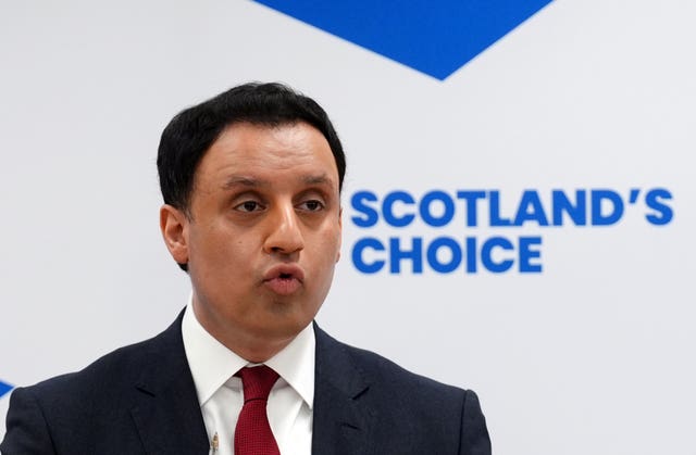 Anas Sarwar speaking in front of a sign reading 'Scotland's choice'