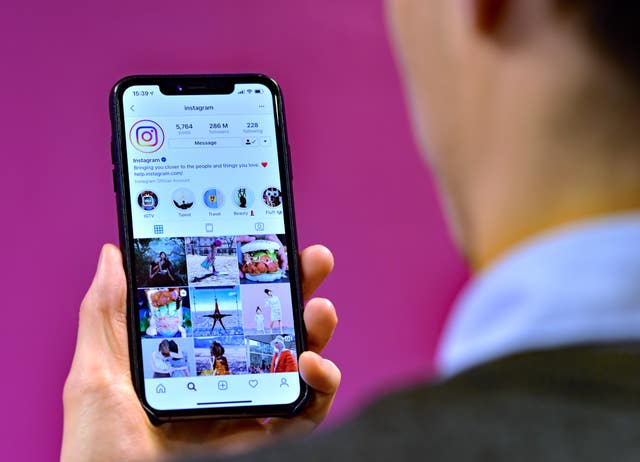 A person looking at the Instagram app displayed on a smartphone