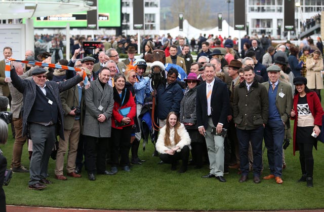 Nico De Boinville and connections of Marie’s Rock celebrate after winning the Close Brothers Mares’ Hurdle during day one of the Cheltenham Festival at Cheltenham Racecourse 