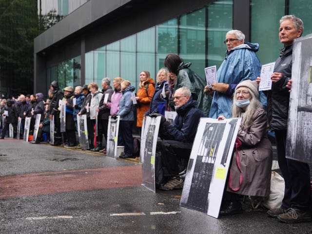 A line of people holding posters