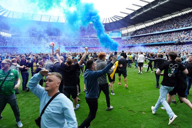 Manchester City scored three times in a madcap six-minute period, prompting thousands of fans to spill on to the pitch at full-time (Martin Rickett/PA)