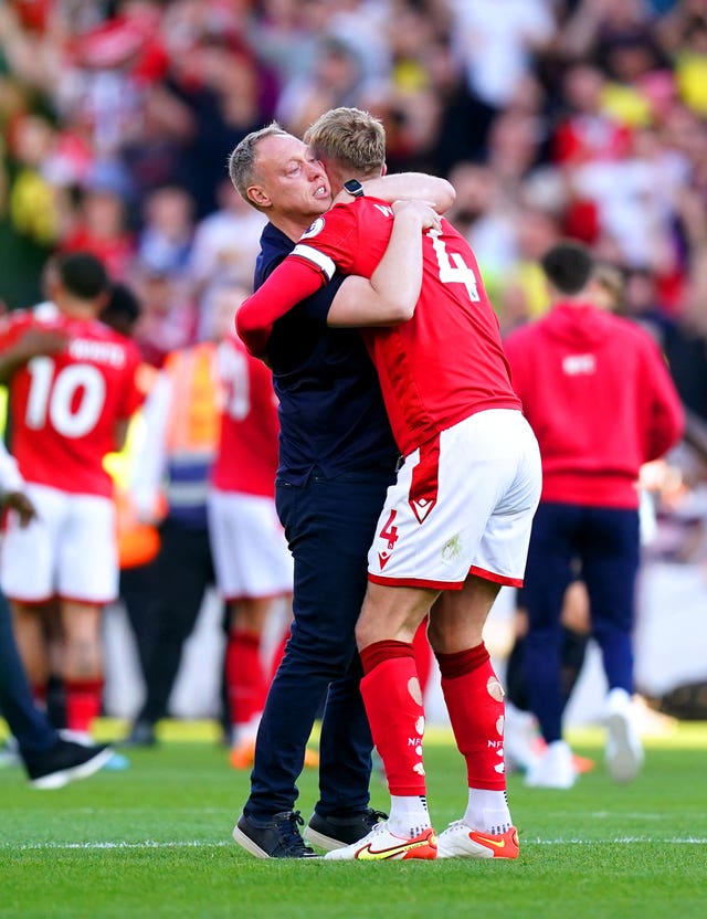 Steve Cooper, left, embraces captain Joe Worrall at the final whistle