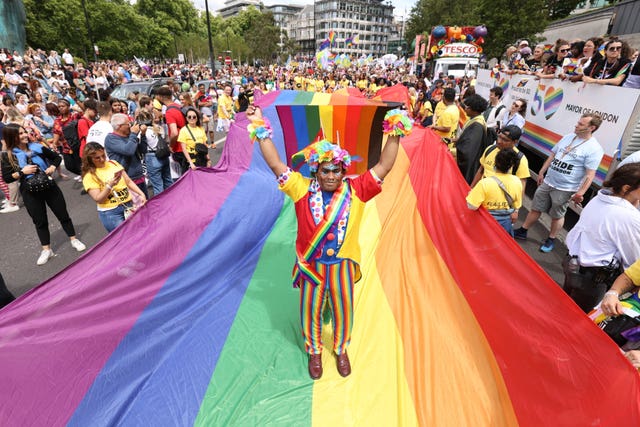 A man waves a pride flag on Park Lane