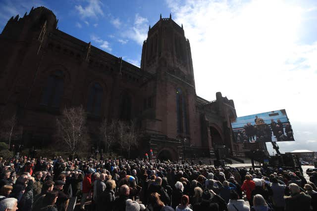 Crowds outside Liverpool Anglican Cathedral watch the funeral service on a big screen (Peter Byrne/PA)