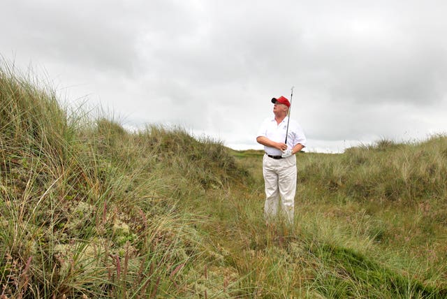Donald Trump plays from the rough on a visit to his golf course near Aberdeen