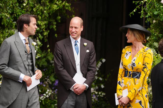 The Prince of Wales in a morning suit chats with guests outside Chester Cathedral for the Duke and Duchess of Westminster's wedding last year