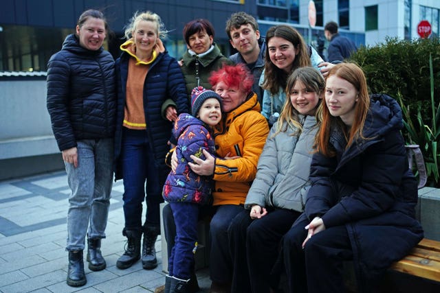 Callum Clarke (back row, second right), 27, and his wife Vitalina (back row, right), 23, from Reading in Berkshire, are reunited with her family in Rzeszow, Poland