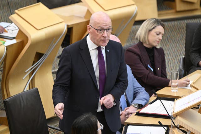 John Swinney standing while speaking in Holyrood