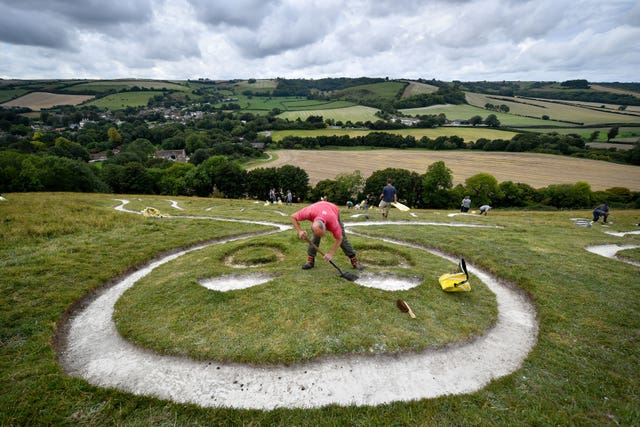 Volunteers refreshed the Giant's chalk (Ben Birchall/PA).