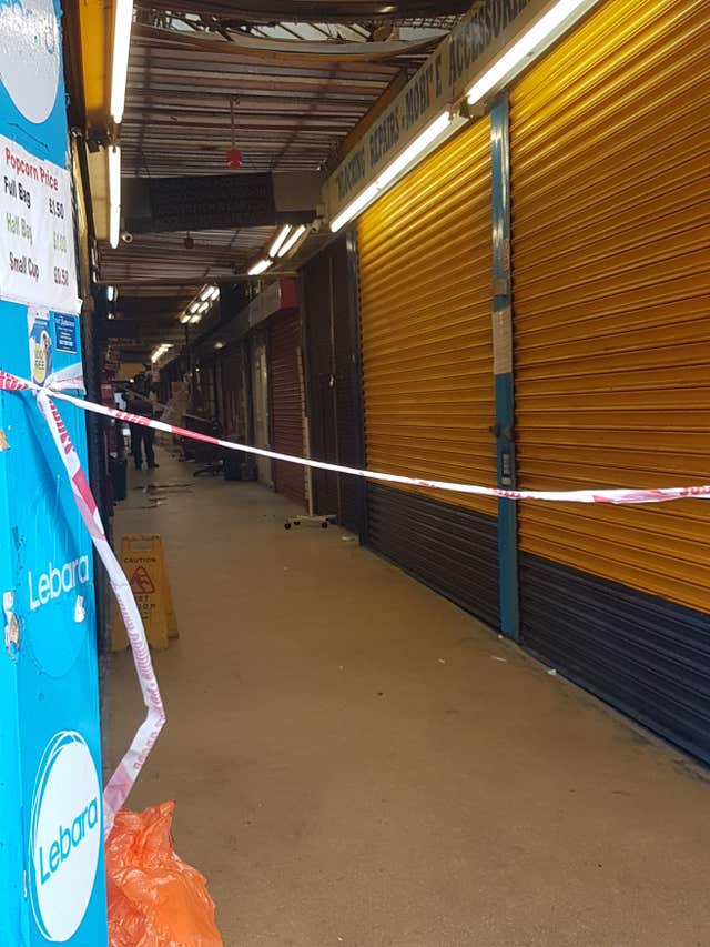 Police tape at the Reliance Arcade between Brixton Road and Electric Lane in south London, where a woman sought help from shopkeepers (Tess De La Mare/PA)