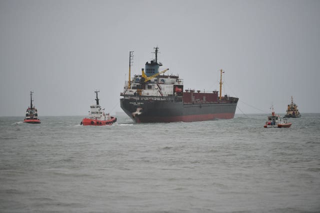 Tug boats help the Kuzma Minin re-float during high tide (Ben Birchall/PA).
