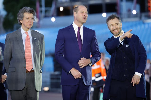 Designer Thomas Heatherwick points forward as he stands next to the then-Duke of Cambridge during the lighting of the Principal Beacon at the Tree of Trees sculpture outside Buckingham Palace in 2022