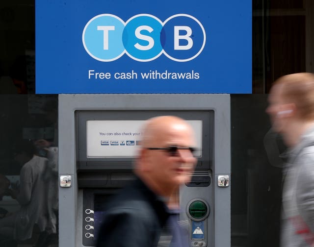 People pass a TSB cash machine in Ashford, Kent,