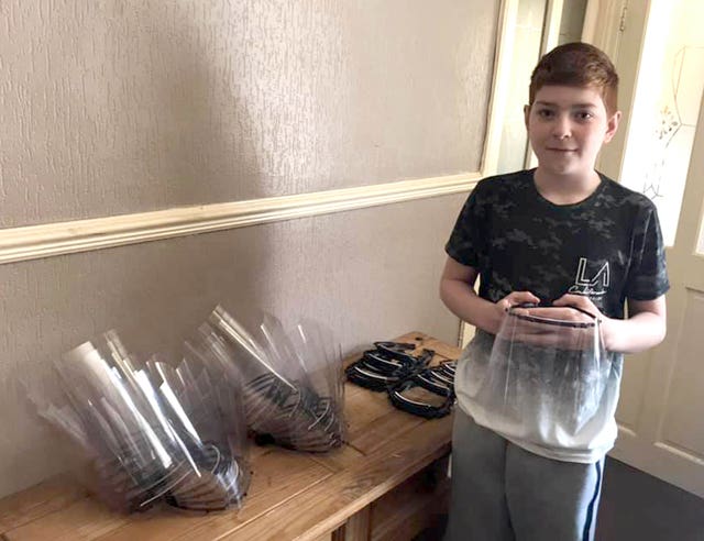Undated family handout photo issued by North Yorkshire County Council of William Stainton, 13, of Scarborough, with some of the PPE he has made for nursing homes across Scarborough and Bridlington as well as for local chemists, with a 3-D printer he bought with holiday money
