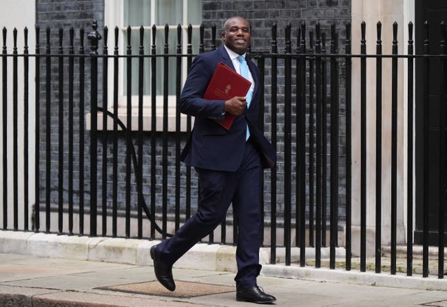 David Lammy walks down Downing Street with a red ministerial folder under his arm