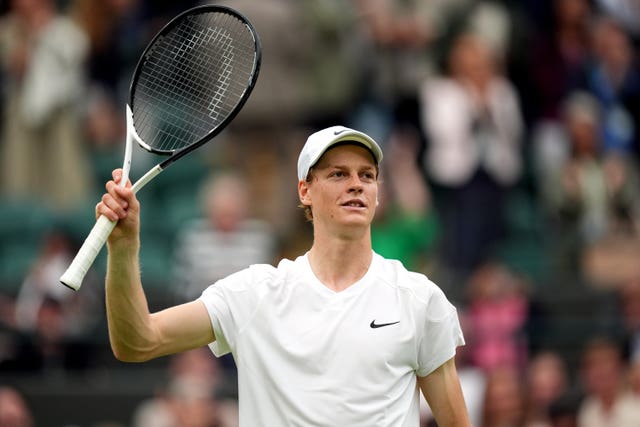 Jannik Sinner raises his racket to the crowd