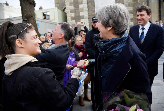 Prime Minister Theresa May fist bumps a member of the public as she greets people after visiting the scene where former Russian intelligence officer Sergei Skripal and his daughter Yulia were found after they were poisoned with a nerve agent, in Salisbury (Toby Melville/PA)