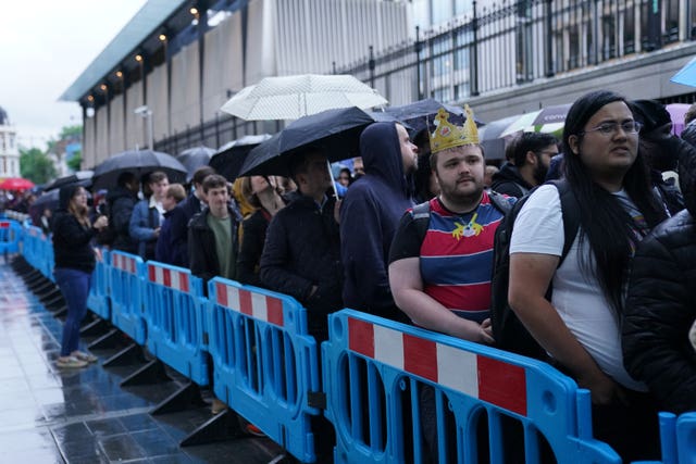 Crowds wait in line to board the first Elizabeth line train to carry passengers at Paddington Station, London (Kirsty O'Connor/PA)