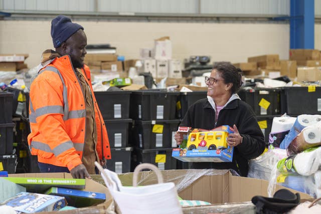 (l to r) Mohammed Konateh and Seetha Bamunuvitharana pack goods at the new facility